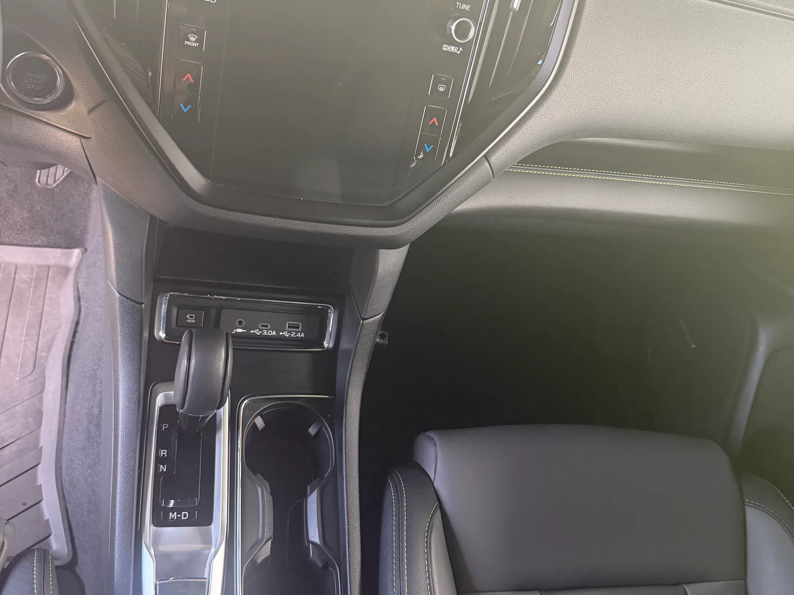 Clean Subaru center console and cup holders.